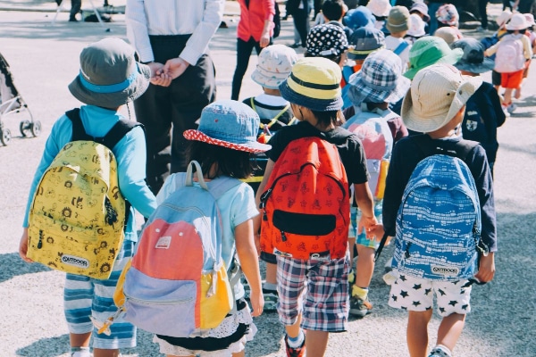 lined up children holding hands style of classroom management at school