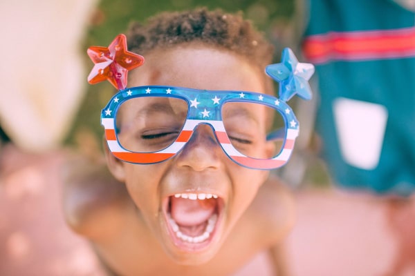 child screaming with American sunglasses on